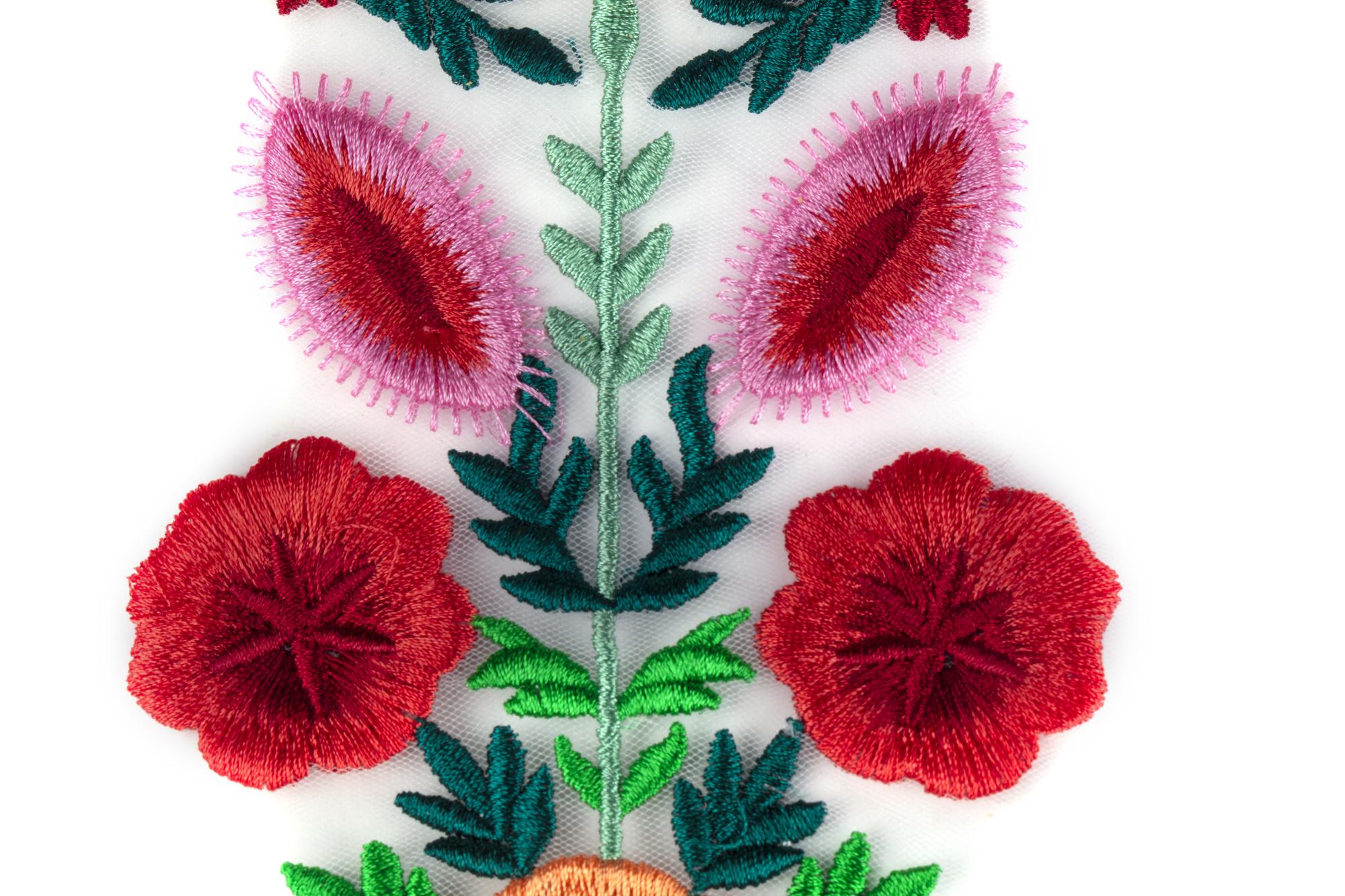 Close-up embroidered floral detail on cotton